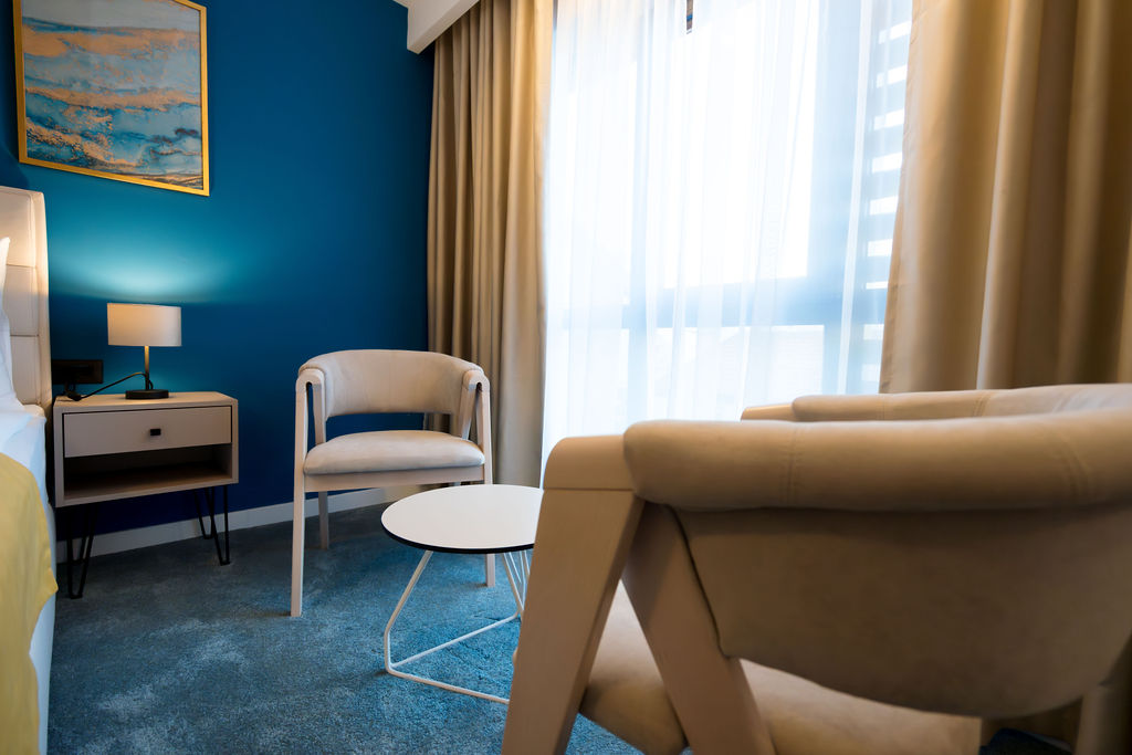 Room with blue feature wall and seating area