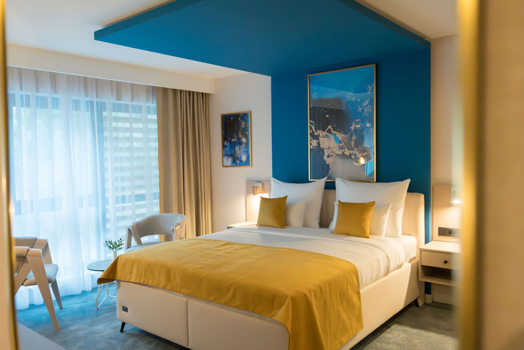 Suite bed framed by signature blue artwork